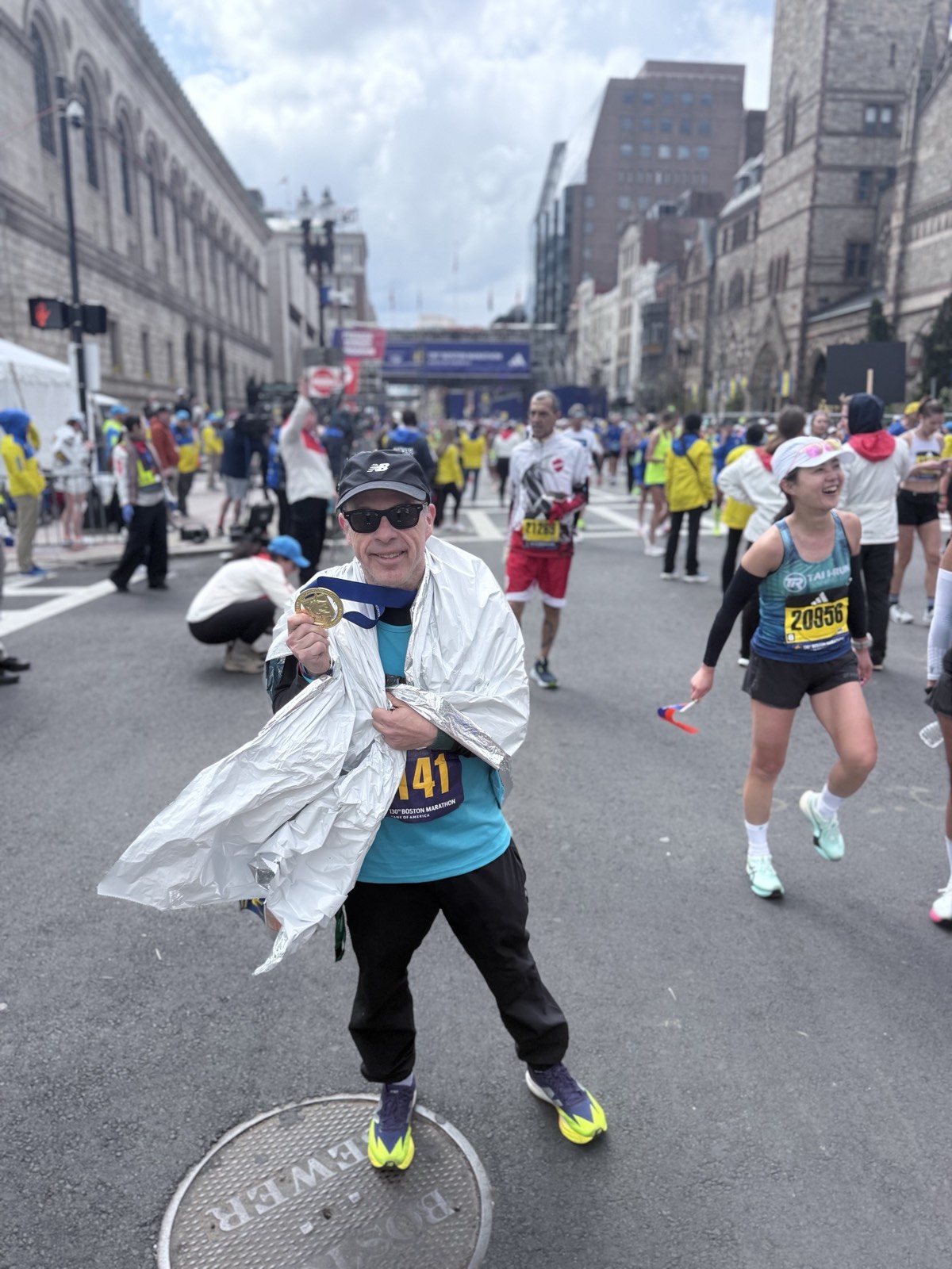 Dan Alperin crossing the finish line at the 130th Boston Marathon 2026